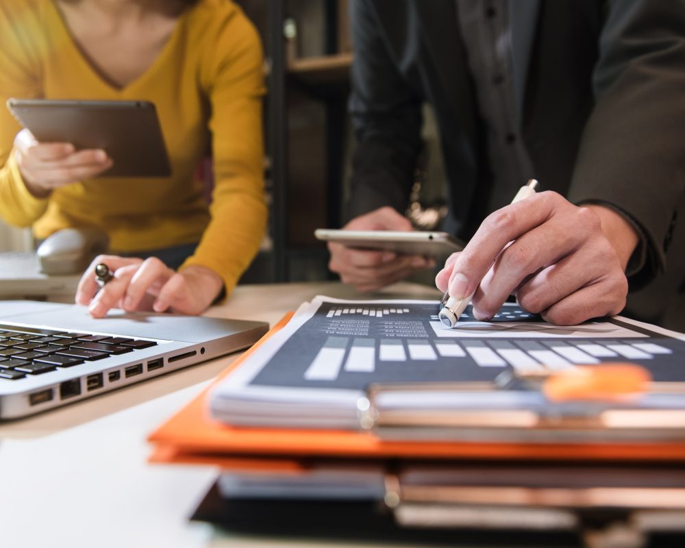 Business documents on office table with smart phone